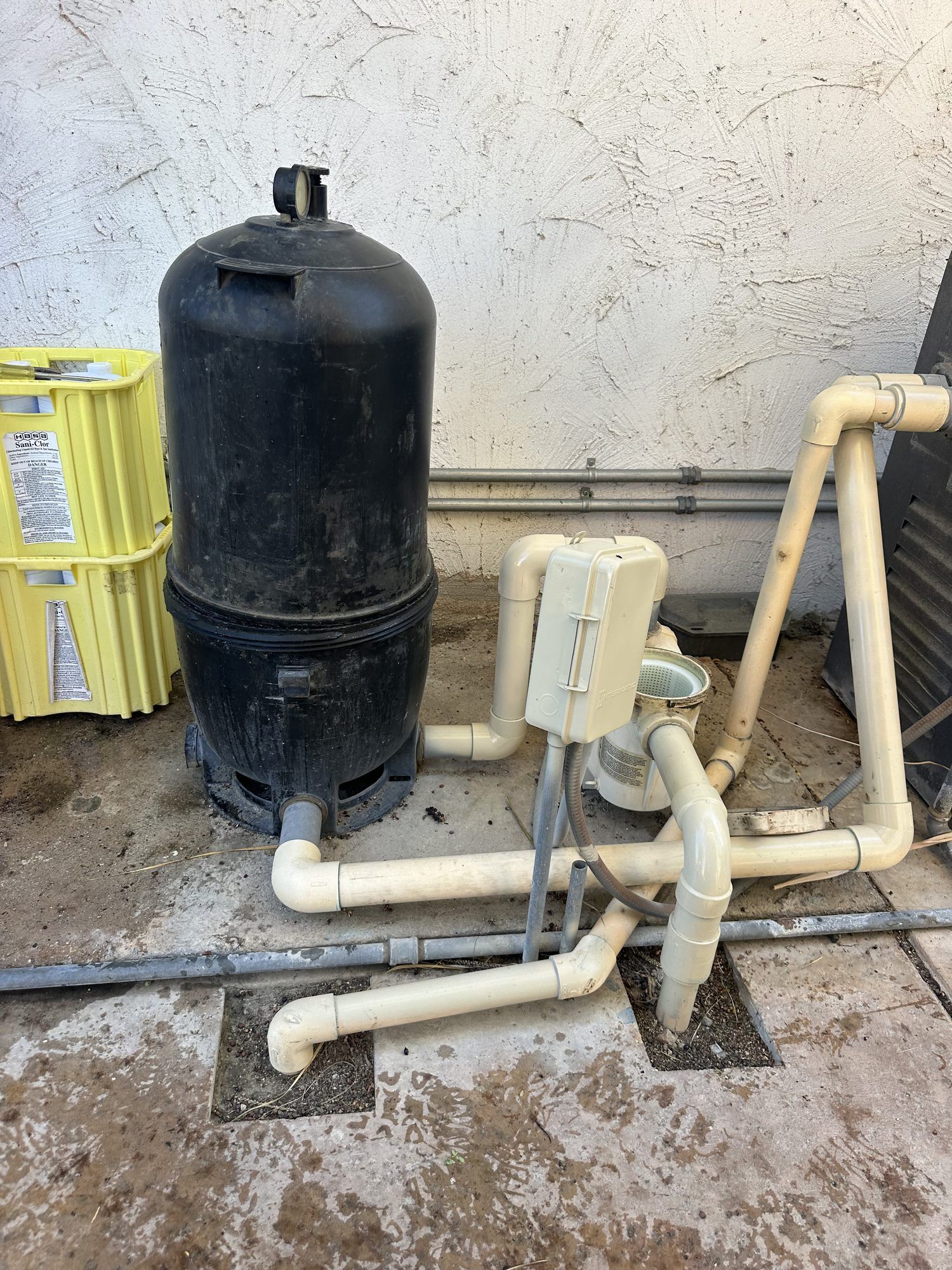 Old black pool filter at the equipment pad
