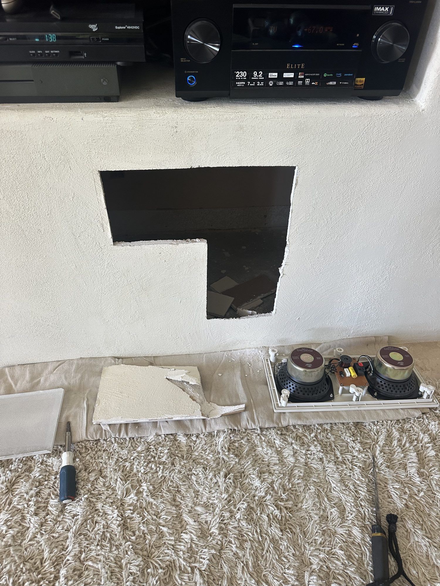 Opening cut into a wall below a TV cabinet